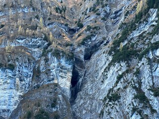 Fototapeta na wymiar Steep stone cliffs and vertical rocks above the reservoir lake Gigerwaldsee (Gigerwald Lake) in the UNESCO World Heritage Tectonic Arena Sardona (UNESCO-Welterbe Tektonikarena Sardona) - Switzerland