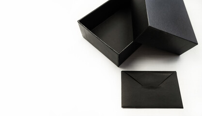 Open black box with an envelope on a white background. Holiday concept, gift.