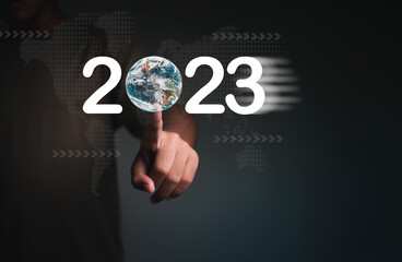 Businessman hand touching globe change from 2022 to 2023 for Goal, Target, Resolution, strategy, plan, Action, mission, motivation, and New Year startup business concepts