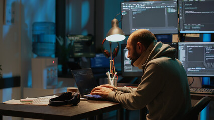 Male employee wearing cervical neck collar at app developing job, suffering from spinal injury at night. Young man with medical spine brace programming web language on terminal window.