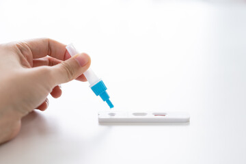woman holding a rapid antigen test kit
