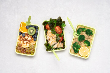 Ready meals for Breakfast, lunch, dinner in green recyclable containers on a white background. Delivery menu, lunch box concept
