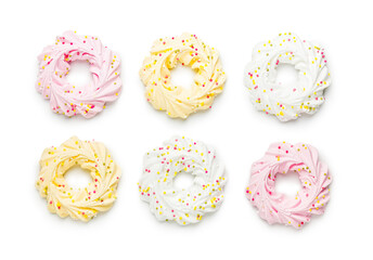 Different colors meringues with sprinkles isolated on white background.