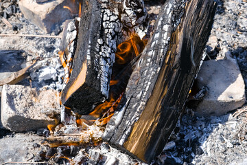 Barbecue place with flaming and burning firewood, close-up. Cooking on a campfire. Firewood and...