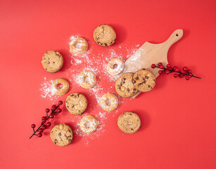 Creative Christmas food concept of sweet homemade cookies, flat lay on red background. A nice New Year's delicious treat for the whole happy family.