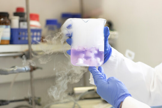 Hands of scientist experimenting with liquid nitrogen in laboratory