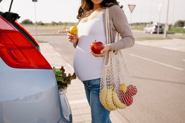 Pregnant woman enjoys shopping for groceries to make lunch.