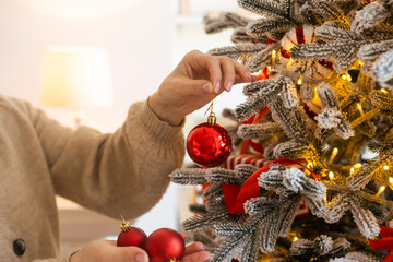 blonde stylish woman decorating christmas tree