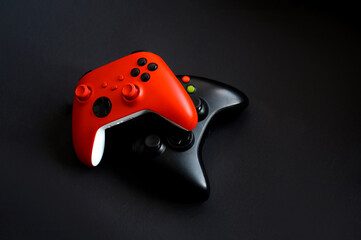 Two gamepads on a black background. The concept of the game, esports, leisure, gaming industry, video games. © Мария Охметзянова