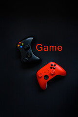 Testk "Game" Two gamepads on a black background. Game concept, esports, leisure, gaming industry, video games. Flat lay, top view © Мария Охметзянова