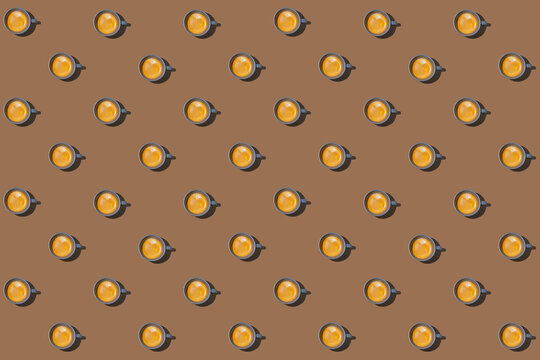 Pattern of cups of coffee standing in rows against brown background