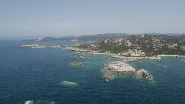 Rocky shore formations on Tizzano Beach in Southwest Corsica Island France, Mediterranean Sea, Aerial pan left reveal shot