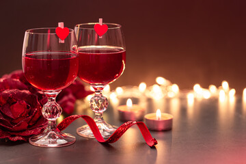 Background for Valentine's Day with glasses of wine on a blurred background.