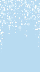 Fototapeta premium Snowy christmas background. Subtle flying snow flakes and stars on light blue winter backdrop. Delicate sweet snowy christmas. Vertical vector illustration.
