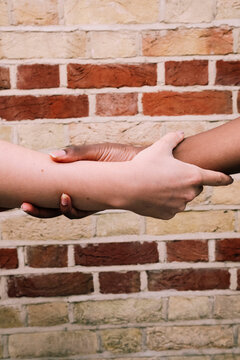 Multiracial friends holding hands in unity