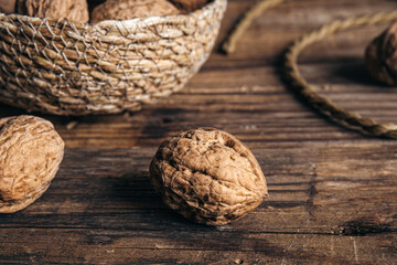 Close-up, whole walnuts on a wooden background, rustic style.