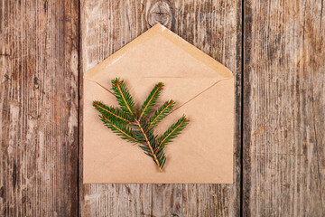 Christmas composition. Fir branch and envelope envelope made of craft paper