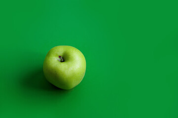 Green apple on a green background. Diet. Place for text.