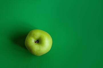 Green apple on a green background. Diet. Place for text.