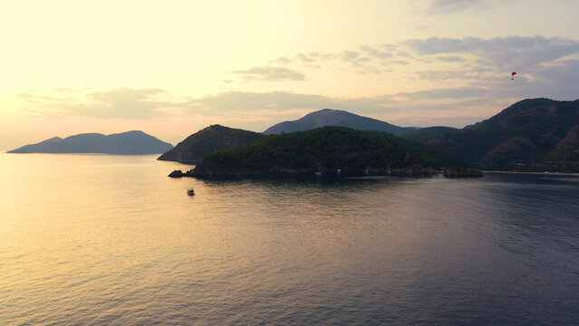Scenic view of majestic sunset over sea and mountains. Marine nature landscape in the evening.