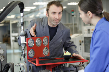 man showing female appretice differential pressure gate
