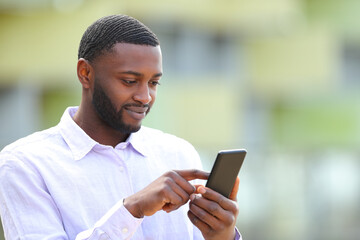 Black man browsing content on phone
