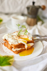 Breakfast on white bed sheets, good morning, toast with poached eggs, coffee, flowers, Hotel room early morning, honeymoon