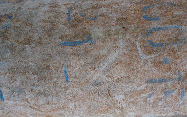 Old concrete wall with light blue and black swirls of color background texture