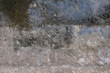 Old concrete wall with light blue paint and black mold and mortar grunge background texture