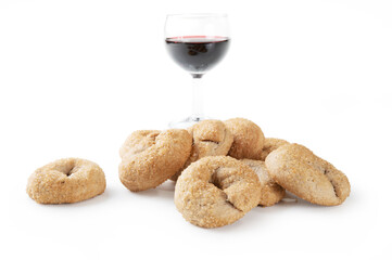 Red wine donuts, with red wine glass, isolated on white background, close-up. - 549667858