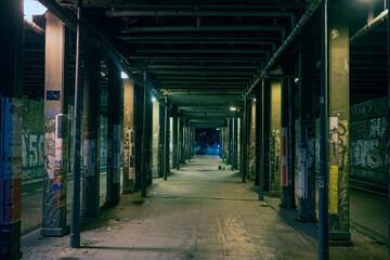 Empty footpath amidst colonnade in city