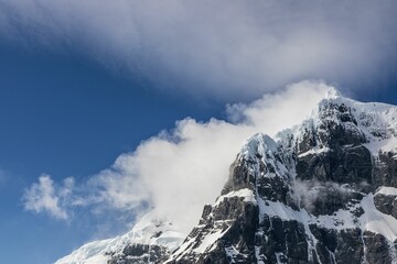 Low angle shot of the mountains covered with snow and fog, Antarctica