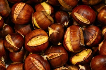 Roasted chestnuts. close up and selective focus. Autumn background, top view.