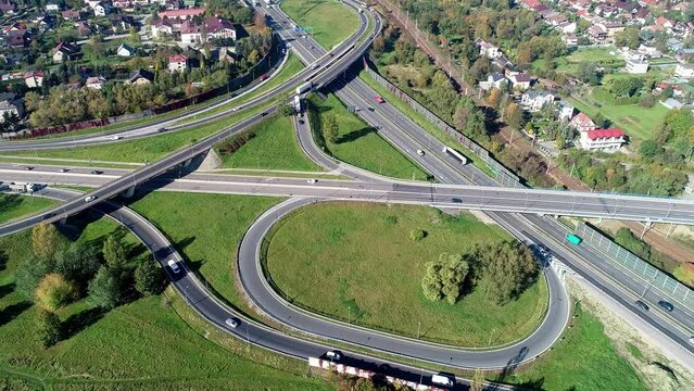 Highway multilevel crossing. Spaghetti junction on A4 international highway with Zakopianska multilane street and railway, the part of freeway around Krakow, Poland. Aerial view from above 