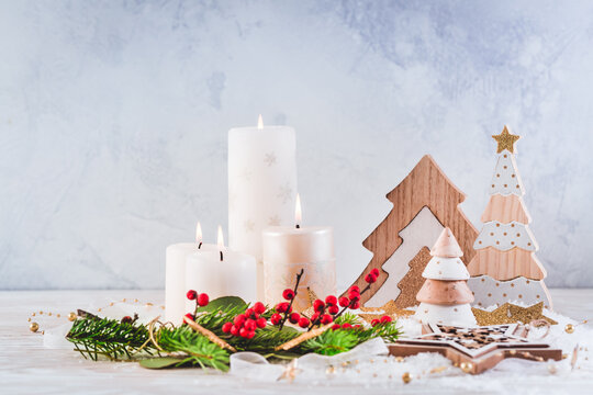 Christmas decoration with candles and wooden Christmas trees