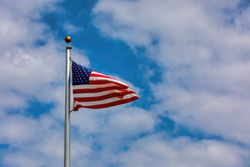 American Flag on a flagpole flying in the wind