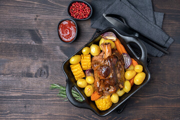 Pork shank knuckle with baked potatoes and corn - obrazy, fototapety, plakaty