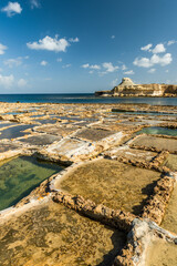 Traditional salt pans in Xwejni Bay on the beach of island of Gozo, Malta.