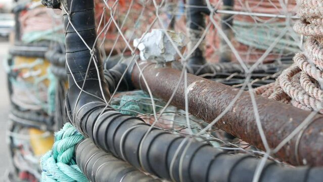 Traps, ropes and cages on pier, commercial dock, fishing industry, Monterey California USA. Empty pots, creels for fish seafood catching in port. Many fisherman's nets and baskets in seaport. Fishery.