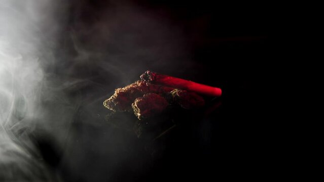 Fast flashing police lights over cannabis joint and weed on a smoke background