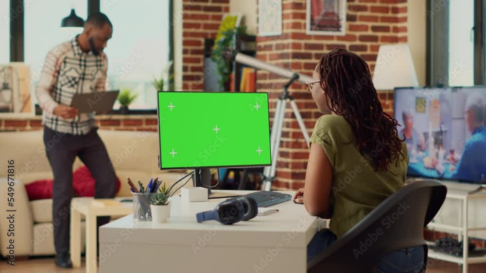 Poster female freelancer using computer with greenscreen, work from home with chroma key display. professio
