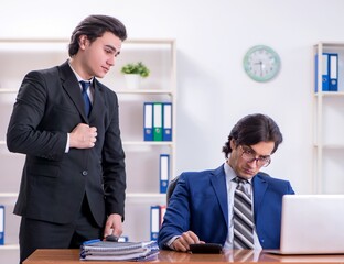 Boss and his male assistant working in the office
