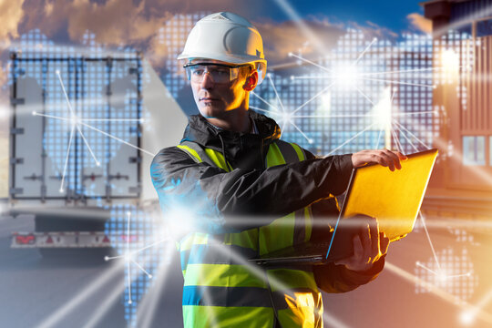 Man logistician with laptop. Dispatcher logistics company near truck. Transport logistics. Transportation goods on trucks. Automobile cargo transportation. Man in reflective vest and helmet