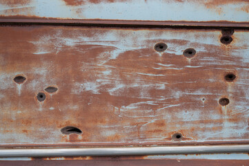 Old abandoned r Sedan Delivery, it is rusty and with bullet holes