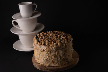 photo of the cake with cups standing in a row in the background