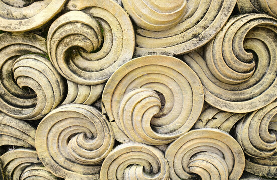 Close Up Of Old Yellow Concrete Swirls Design On Wall In Bali. Background And Wallpaper Texture