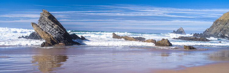 spectacular cliffs, sharp rocks, wild beaches and big waves on the Algarve coast. Ocean View. Horizontal, daylight