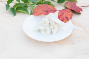 Shea butter on light background, unrefined, close up	