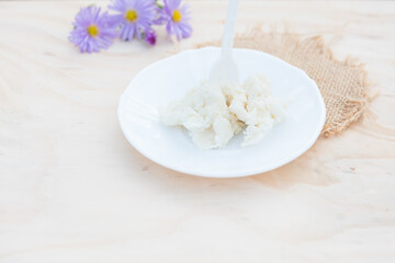 Shea butter on light background, unrefined, close up	