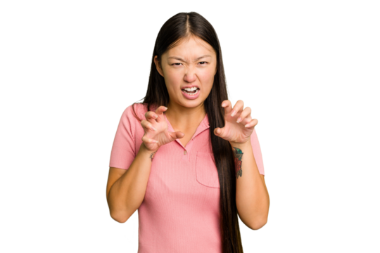 Young Asian woman isolated showing claws imitating a cat, aggressive gesture.